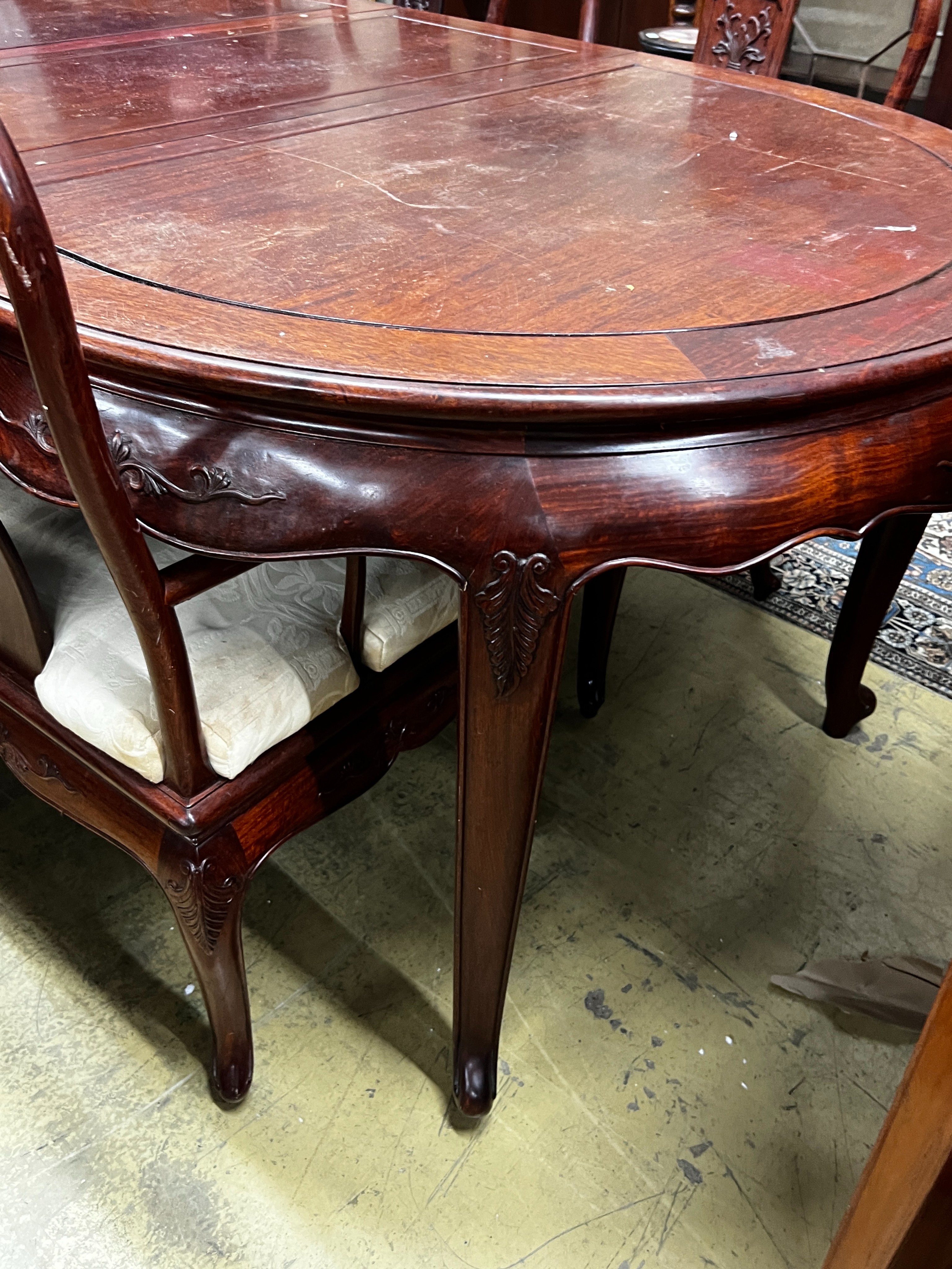 A Chinese hardwood extending dining table, length 244cm extended, two spare leaves, width 110cm, height 78cm and six chairs (2 with arms)